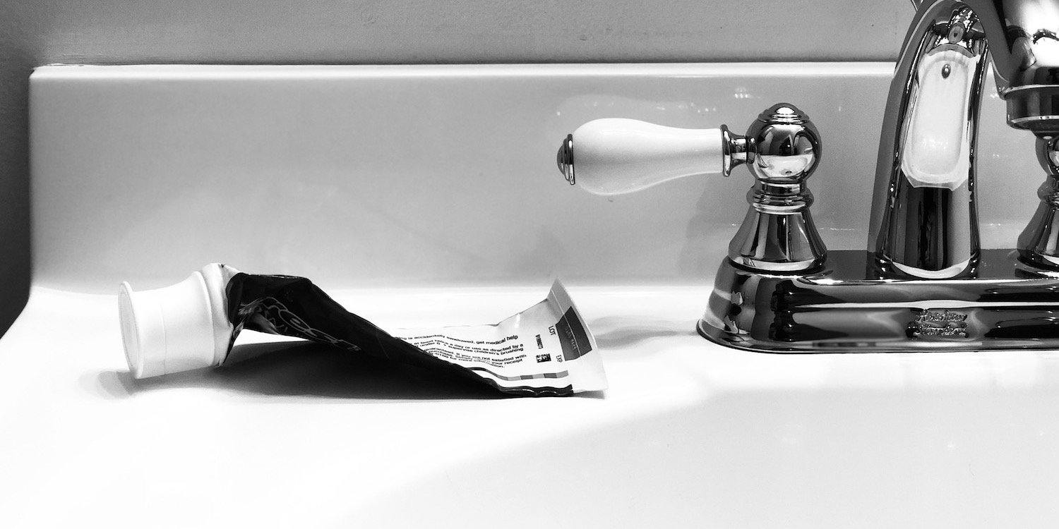 Empty Toothpaste Tube On Sink Counter